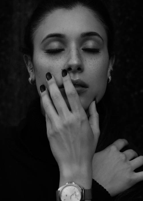 Black and white portrait of a woman with eyes closed, conveying the weight of decision fatigue